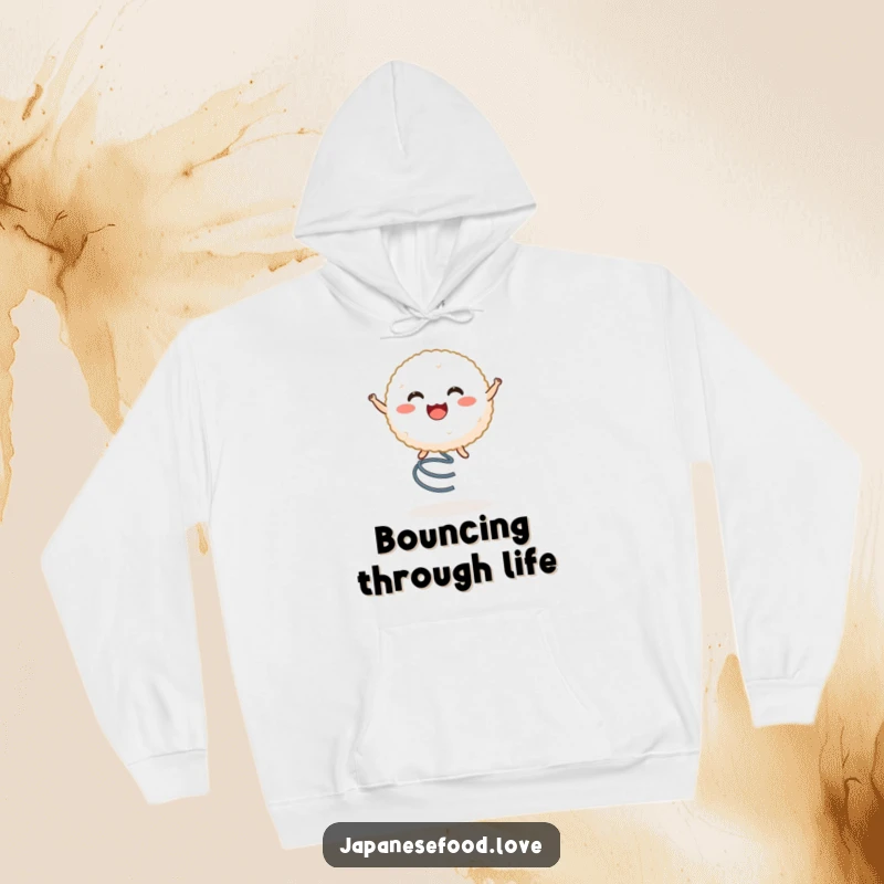 Funny hoodie displaying a happy rice ball character energetically bouncing on a spring, perfect for cozy, humorous wear.