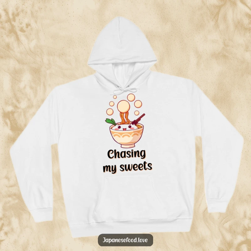 Funny hoodie featuring a happy ramen bowl character catching floating dango, offering warmth and playful design.