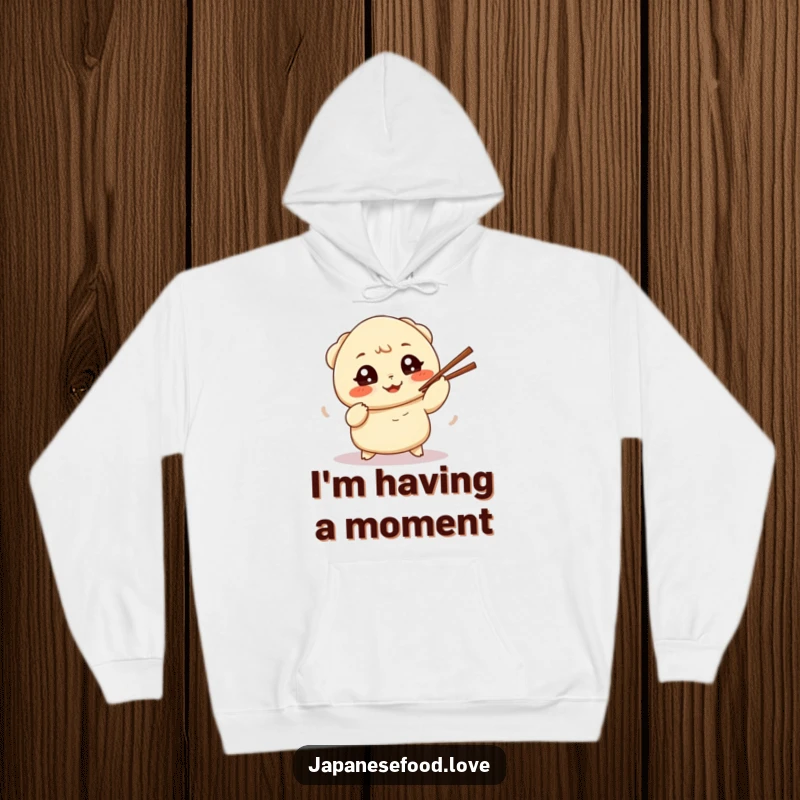 Funny hoodie featuring a cheerful dumpling comically juggling chopsticks, perfect for showcasing a love for food and fun.