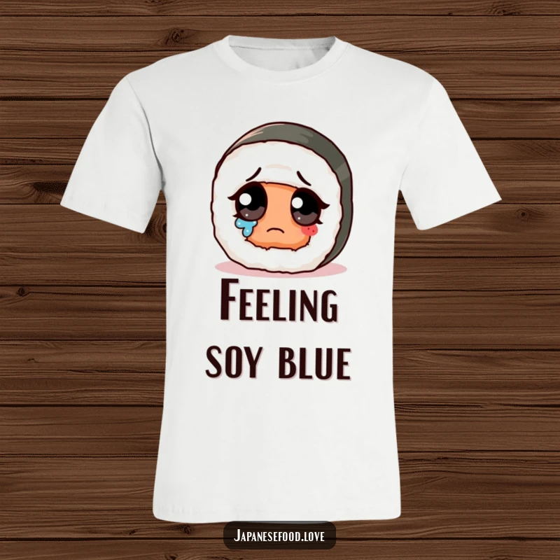 Funny sad cute sushi roll with giant eye wiping a tear on a t-shirt, a humorous depiction of sadness.